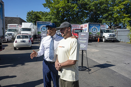 New York City Mayor Eric Adams (L) poses with Iovanny Medina during his announcement on major expansion of big-rig training program for justice-involved New Yorkers with Mayor's Office of Criminal Justice and Emerge Career at Ferrari Driving School's yard in the Queens borough of New York City.