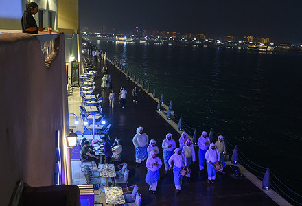 Qatari men perform Musaharati, beating drums and singing traditional songs to wake residents for the pre-dawn suhoor meal during the holy month of Ramadan at Old Doha Port. The suhoor meal is the last meal before a long day of fasting that starts with the call to prayer at sunrise during the month of Ramadan.