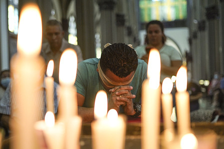 Victor Martinez, 30, a penitent, praying while blindfolded in the El Calvario church after crawling as a way of sacrifice, during Easter Week. During the Easter Week, believers commemorate the death and resurrection of Jesus Christ.