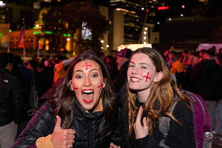English fans celebrate their win the game at Federation Square during the Women's World Cup semifinal in Melbourne. Australian and English soccer fans gather at Federation Square to share in the exhilarating highs and heart-wrenching lows of the World Cup semifinal clash. Flags wave, cheers resonate, and emotions intertwine as these passionate supporters unite in their love for the game, watching the Lionesses win 3 :1 against the Matildas.