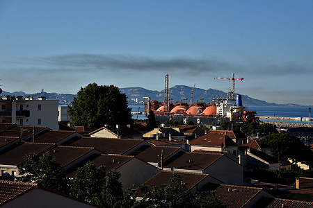 View of a thick cloud of black smoke floating in the sky above the port of Marseille. Fumes from boats moored in the large port of Marseille are largely responsible for the city's air pollution. Fumes from freight ships using heavy fuel oil as fuel are the main cause of harmful emissions.