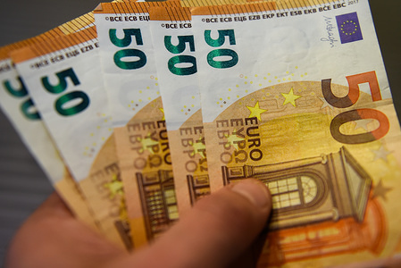 In this photo illustration 50 Euro banknotes seen displayed.