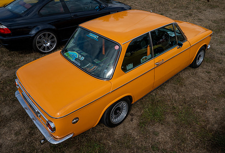 A vintage orange 1973 BMW 2002 seen displayed at the annual M-Powered BMW and Alpina car meet hosted by the Surrey and Sussex BMW Owners Club at Denbies Wine Estate. The Surrey and Sussex BMW Owners Club hosts its annual M-Powered BMW and Alpina car meet at Denbies Wine Estate in Dorking, Surrey, on Sunday 30 August 2026. The event features more than BMWs, including M-Powered and M-Lite models alongside prestigious Alpina cars, with trade stands and a show-and-shine competition held against the backdrop of the Surrey Hills.