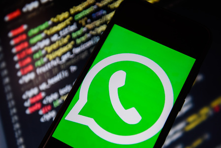 In this photo illustration a WhatsApp logo seen displayed on a smartphone.