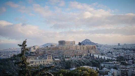 A general view of the Acropolis Hill (L) and Lykavvitos Hill (R) covered with snow in the early hours on Tuesday. A snow storm ''Tilemachos'' sweeps over Athens is keeping the mercury far below zero across swathes of the country.