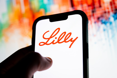 In this photo illustration, a Lilly logo seen displayed on a smartphone.