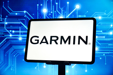 In this photo illustration, the Garmin logo is displayed on the screen of a smart tablet.