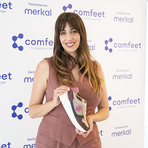 Almudena Cid poses with a shoe as she is presented as the new face of Comfeet at Espacio Larra in Madrid.