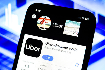 In this photo illustration, an Uber app logo is displayed on an iPhone in the Apple Store.