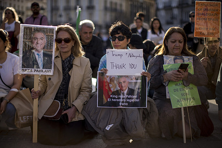 A woman from the Iranian community in Madrid holds a placard that reads "Trump, Netanyahu, thank you" during a protest in Puerta del Sol in the center of Madrid, in support of the Iranian people following the attacks by the United States and Israel.