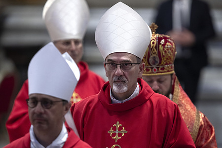 Cardinal Pierbattista Pizzaballa leaves at the end of a mass on the seventh day of the "Novendiali," nine days of mourning for late Pope Francis, in St. Peter's Basilica at the Vatican. As the Vatican continues the Novendiali, a solemn nine-day mourning period for the late Pope Francis, faithful from around the world gather daily in St. Peter’s Basilica to honor his memory. On the seventh day, the conclusion of the mass marked another poignant moment in a series of rituals reflecting the Church’s reverence for the late pontiff's spiritual legacy and leadership.