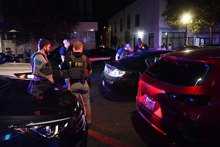 FBI agents conducted a traffic stop on a vehicle along with the Metropolitan Police Department on U Street NW during the evening in Washington, D.C., United States on August 15, 2025. The traffic stop with assistance from the federal agents in the area is part of President Donald Trump's crime reduction plan for the District of Columbia.