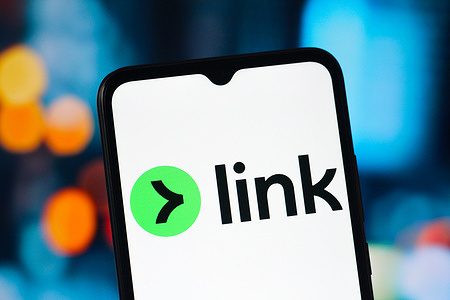 In this photo illustration, the Link logo is seen displayed on a smartphone screen.