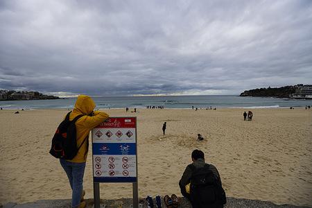 Visitors are seen enjoying Bondi Beach in Sydney. Visitors enjoy mild winter weather at Bondi Beach in Sydney, taking advantage of clear skies for swimming, walking, and relaxing. The iconic beach attracts around 2.6 million visitors annually.