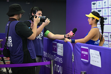 Alex Eala (R) of the Philippines is seen during the 19th Asian Games Tennis Woman Single match against Kyoka Okamura (not in the photo) of Japan held at the Hangzhou Olympic Sports Centre Tennis Centre. Final score Eala 2:1 Okamura.