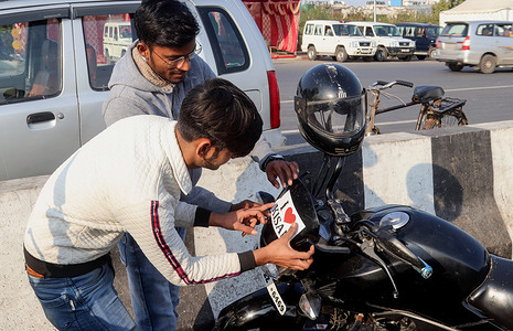 A youth sticks a 'I Love Kisan' sticker on his motorcycle during the farmers' demonstration.
For over two months at Ghaizipur (Delhi-Uttar Pradesh border), thousands of protesting farmers call for a countrywide agitation (Chakka Jam) except Delhi, Uttar Pradesh and Uttarakhand to strengthen their demands on repeal of agriculture laws, against repressive measures including suspension of internet, razor wire on top of rows of heavy iron barricades, concrete barricades, cement walls and iron spikes and nails placed on the all main protest site.