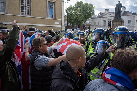 Protesters blame the riot police during the 'Unite the Kingdom' demonstration. Hundreds of thousands of far-right protesters gathered for Tommy Robinson's 'Unite the Kingdom' rally near the Waterloo Station. The protesters marched from the Waterloo station to the Whitehall.