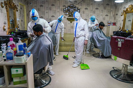 A salon staff wearing a protective suit and facemask is seen cleaning up the salon.Salon staff reinforce protection measures during the coronavirus (COVID-19) disease pandemic.
