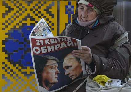 An elderly Ukrainian woman reads a pre-election leaflet of President Poroshenko’s with the image of the President of Ukraine Petro Poroshenko and the President of Russia Vladimir Putin, who look at each other. Text on the leaflet are saying " The 21st of April, Choose" The second round of presidential elections in Ukraine will be held on April 21.