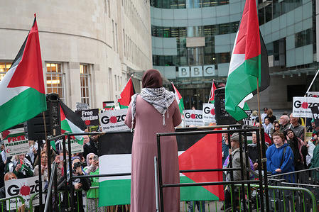 Protesters listen to a speaker during the demonstration outside the BBC. Protesters accused The BBC of shielding Israel from accountability by continuing to suppress the realities of its genocidal violence against Palestinians.