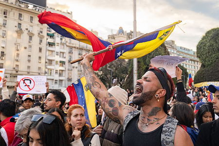 A demonstrator shouts against the regime of the dictator Maduro while waving his flag during the rally. Demonstrators gathered at the obelisk in the city of Buenos Aires to protest against the regime of dictator Nicolas Maduro. The call was made by opposition leader, MarÌa Corina Machado, from Venezuela.