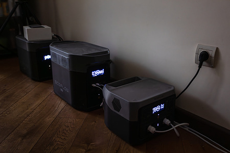 Three EcoFlow portable power stations are seen arranged on a floor in Kyiv, Ukraine, to provide backup electricity during a blackout. The devices are seen displaying battery levels on digital screens while one unit is seen connected to a wall outlet for charging. January 2026 has become one of the most challenging periods for the Ukrainian energy system due to relentless, massive Russian attacks, which experts and human rights advocates characterize as a deliberate and purposeful genocide aimed at eliminating the basic conditions for civilian survival amidst severe winter freezes. The intentional destruction of critical infrastructure—ranging from power generation plants to key substations—is designed to plunge the entire country into a total blackout, stripping millions of heat, water, and communication, an act that constitutes a war crime against humanity. Yet, despite the aggressor’s attempts to break the nation’s will through cold and darkness, the incredible resilience of the Ukrainian people remains unshakable. The heroic efforts of energy workers turn every hour of the struggle for power into a symbol of national resistance, proving that the inner light of Ukrainians cannot be extinguished by any missile strikes.
