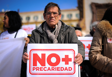 An elderly man holds a sign that reads: "Not more precariousness" as he takes part in a protest against the employment insecurity at Plaza de la Merced square in downtown Málaga, southern of Spain.