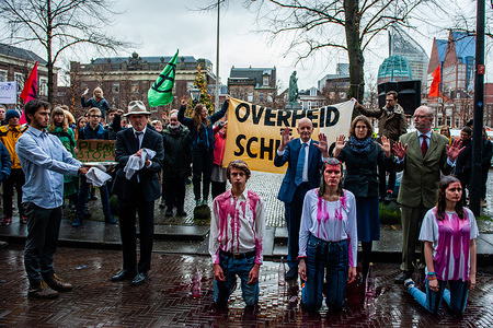 THE HAGUE, NETHERLANDS, DECEMBER 20, 2019:
XR activists performing with fake blood during the demonstration.
People from several climate organisations gathered with eyes painted on their hands symbolising 'We are watching you'. From there they walked to the Tweede Kamer, to demand radical climate action. In front of the Tweede Kamer, the group Extinction Rebellion carried out the performance Blood of our children is on the governments hands.