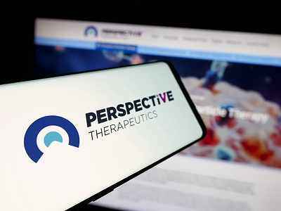 In this photo illustration, a smartphone with the logo of US company Perspective Therapeutics Inc. is seen on screen in front of website.