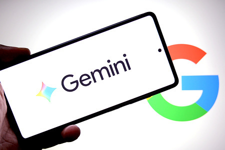In this photo illustration, a Gemini logo is seen displayed on a smartphone with a Google logo in the background.