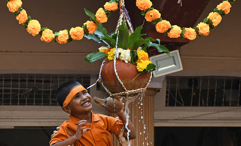 A visually challenged student breaks a pot filled with curd suspended on a rope at a school for the visually challenged on the eve of Janmasthami celebration in Mumbai. Janmashtami is celebrated as birth of lord Krishna by Hindu devotees by singing devotional songs and fasting for a day till the midnight.