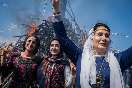 Women pose in front of the Newroz fire during the celebration. At the call of the Peoples' Democratic Party (HDP), thousands celebrated Newroz in Diyarbakir. Newroz or Nowruz means "new day" in Persian, and is celebrated to mark the arrival of spring and the first day of the Iranian calendar. It is widely celebrated in Persian and neighboring regions and is recognised on UNESCO's Intangible Cultural Heritage of Human List.