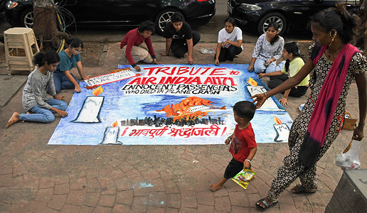Students from Gurukul school of art in Mumbai paint a poster paying tribute to passengers who died in Ahmedabad - London Air India plane crash. Air India plane from Ahmedabad - London carrying 242 passengers crashed shortly after it took off from Sardar Vallabhai Patel International Airport in Ahmedabad's Meghaninagar area. more than 200 passengers died in the tragic plane crash.