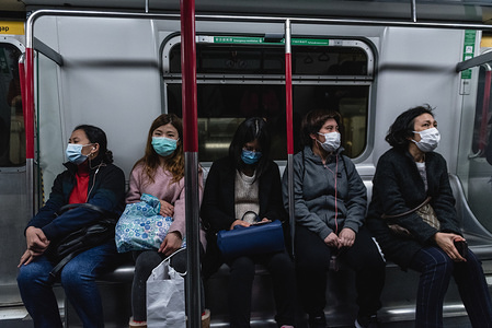 MTR passengers wear surgical face masks on their commute.
Citizens throughout Hong Kong are wearing face masks to prevent against the Coronavirus. Originating in Wuhan, China, the virus has spread beyond China's borders into Hong Kong as well as other countries abroad.