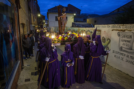 Penitents from the Brotherhood of Our Father Jesus of Nazareth and the Patronage of Saint Joseph carry the image of "Ecce Homo," an anonymous 16th-century polychrome sculpture, during the Holy Thursday procession, which went through the main streets of Sahagun.