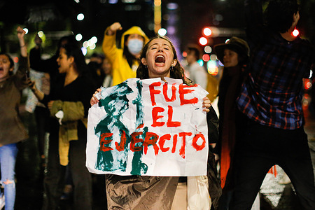 A protester holds a placard during the demonstration. Various activist groups marched from the Angel of Independence to the Senate of the Republic to protest against the recent bill to integrate the National Guard into the Ministry of National Defense (SEDENA) that will be discussed at the Senate these days in Mexico City.