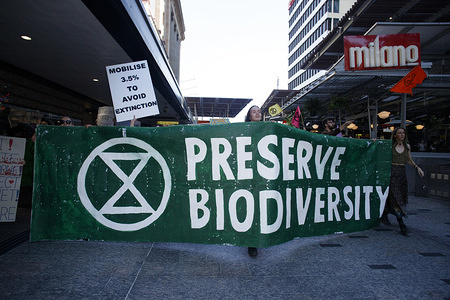 Protesters hold a banner through Queens Street Mall during the Extinction Rebellion demonstration.
Members of the public gather as the 'Extinction Rebellion', an international group that rallies, and causes civil disobedience in the hopes of forcing the government to enact further pollution and climate change policy. People in Brisbane and many other cities around the world gathered on the 6th of August to protest and halt public transport and business in order to meet their demands.