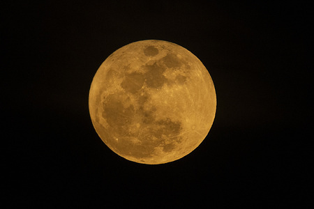 The full “Pink Moon” shines through an overcast night sky over Los Angeles on April 1, 2026.