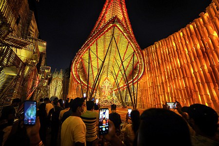 People take photos in front of the entrance of different Pandals (Temporary place for Worship).Durga Puja is the biggest Hindu festival celebrated in Kolkata and runs for 9 days. Kolkata High Court has ordered that access to Public Free Puja Pandals this year to be limited so as to control the spread of Covid19.