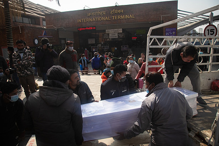 (EDITOR’S NOTE: Image depicts death)
Men loading a coffin with a body on a truck during Tamang’s Cremation, a 28 year old father of 2 kids, worked in a garment factory where he died of a heart attack according to the death certificate.
Along with 19 dead bodies of migrant workers, Surya Bahadur Tamang of Sindhuli was bought back from Malaysia. According to data from the Foreign Employment Board, around 1,000 Nepalese die in labor destination countries each year, despite being declared fit and healthy for work prior to departure. 97% of these deaths occur in Gulf countries.