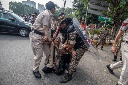 Police officers detain a demonstrator during a Cockroach Janta Party (CJP) protest in New Delhi demanding the resignation of Chief Election Commissioner Gyanesh Kumar over alleged electoral roll irregularities.
