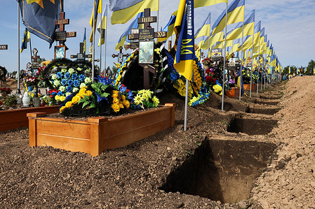 Newly dug empty graves are seen near the tombs of the Ukrainian servicemen in the city cemetery. Ukraine gives no official toll of its war dead—the Ukrainian armed forces have reiterated that their war casualty numbers are a state secret. In February 2024, Ukrainian President Volodymyr Zelenskyy announced that an estimated 31,000 Ukrainian soldiers have been killed in action during the two-year war against Russia. He also stated that "tens of thousands of civilians" have been killed since the onset of the war, but precise figures are not yet available as the conflict is still ongoing.