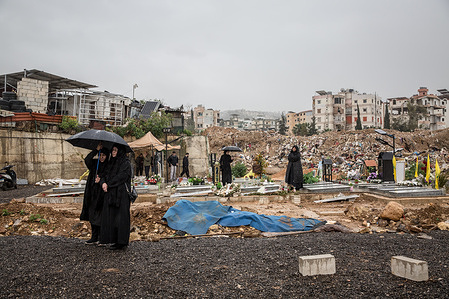 Mourners seen at a cemetery in Choueifat, south of Beirut, during a funeral ceremony, for three journalists killed the previous day by Israeli airstrikes. Ali Shoeib, a reporter for Hezbollah-affiliated Al Manar TV, and Fatima Ftouni and her brother, cameraman Mohamed Ftouni, from the channel Al Mayadeen, were killed in Jezzine, southern Lebanon. At least 1,189 people have been killed in Lebanon since all-out war restarted between Israel and Hezbollah on March 2, says Lebanon's ministry of health.