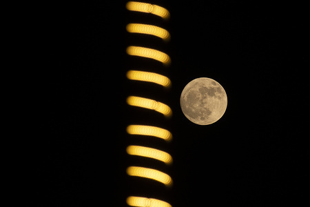 The Strawberry Moon rises over the sky in Srinagar in Indian administered Kashmir. Skywatchers around the world observed June’s full moon, which appeared unusually low and golden due to a rare lunar standstill, a phenomenon that alters the moon’s path every 18.6 years. The name "Strawberry Moon" was originally used by Native American tribes to mark the short harvest season for wild strawberries in early summer.