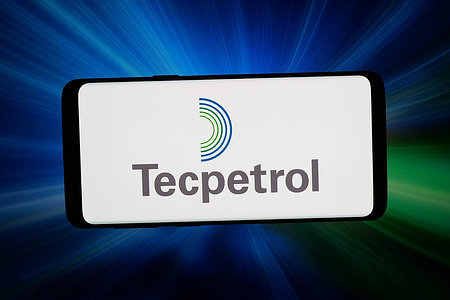 In this photo illustration, the logo of Argentinean petroleum company Tecpetrol S.A. is displayed on a smartphone in front of abstract background on computer screen.