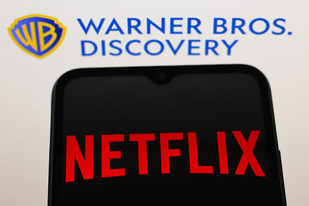 In this photo illustration, the Netflix logo is seen displayed on a smartphone screen and a Warner Bros. Discovery logo in the background.