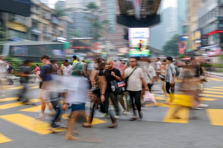 People are seen crossing a junction near a shopping district in Kuala Lumpur. The Ministry of Education announced school closures across affected Malaysian states where the Air Pollutant Index (API) surpasses the 180 threshold, effective October 9. The preventive measure comes as transboundary haze from land clearing fires in Sumatra and Kalimantan blanketed Kuala Lumpur, triggering public health advisories and nationwide pollution monitoring.