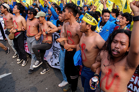 Student protesters are seen shirtless with markings on their chests during a protest over fuel price hike in Jakarta. Students take to the streets of Jakarta in protest against the 30 percent increase in fuel prices in the country.