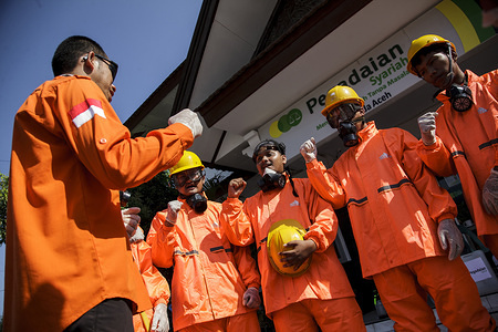 Volunteers dressed in protective suits prepare to spray disinfectants at a government office as a preventive measure against the spread of Coronavirus in Banda Aceh.
Indonesia currently has 450 confirmed COVID-19 cases, with 38 deaths.