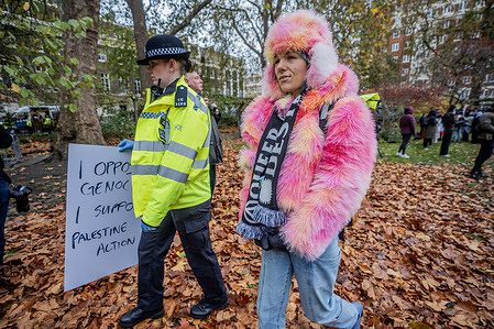 A Palestine Action supporter is led towards awaiting Police vans as scores of protestors were arrested in the Peace Garden in Tavistock Square for holding up signs in support of the proscribed group. Scores of Palestine Action protestors were arrested at the Peace Garden in Tavistock Square for holding up signs in support of the proscribed group. The mass action is part of a renewed nationwide campaign leading up to the judicial review of the Palestine Action ban under the Terrorism Act next week.